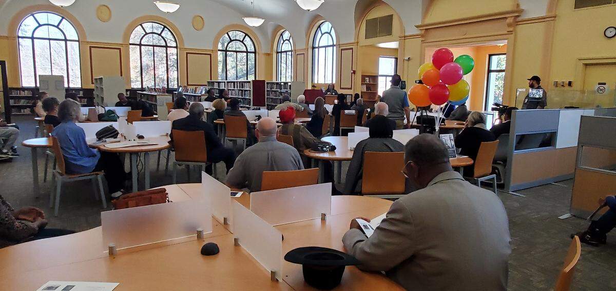 Friends of the library gather during the ceremony honoring Herbert Tuggle.