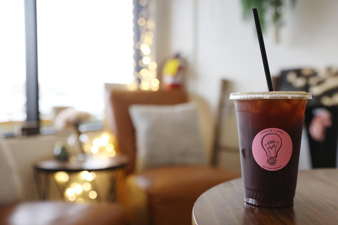 An iced Americano sits on a table inside of Little Light Coffee Co. in Warner Robins. Kevin Norrell, who now owns the popular gathering spot with his wife, Jaimi, shared that the “Americano iced black” is his favorite coffee at the shop.