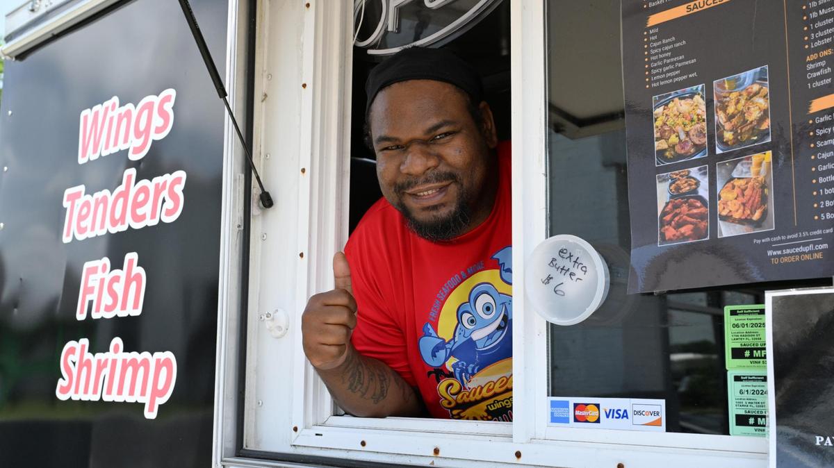 Sauced Up owner Charlie Jonas poses from his food truck on Friday, April 25, 2025, off of Martin Luther King Jr. Boulevard, in Macon, Georgia. Jonas moved to Macon from Florida with his food truck, which specializes in seafood.