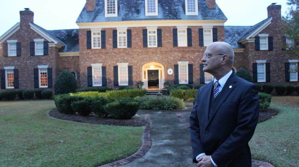 Bruce Allen stands in front of his house, which doubles as an office and consul retreat for his fellow consuls to Liechtenstein.