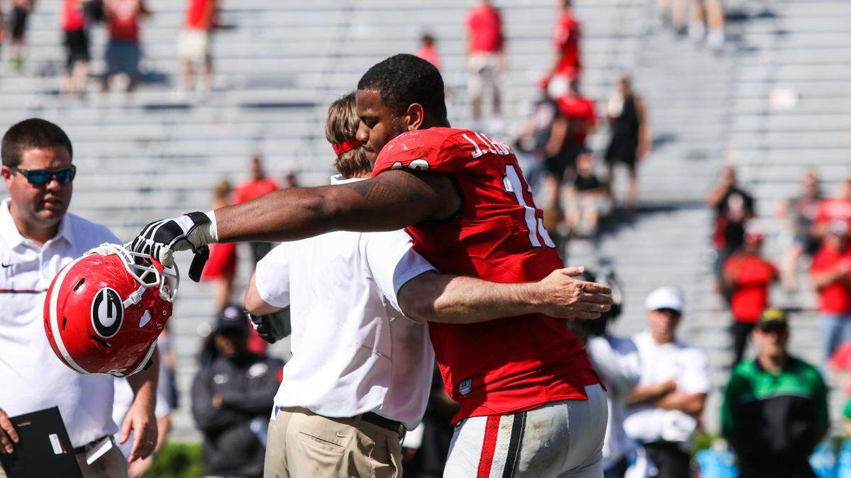 Jonathan Ledbetter and Kirby Smart embrace in a hug at Georgia's G-Day spring game in 2017.