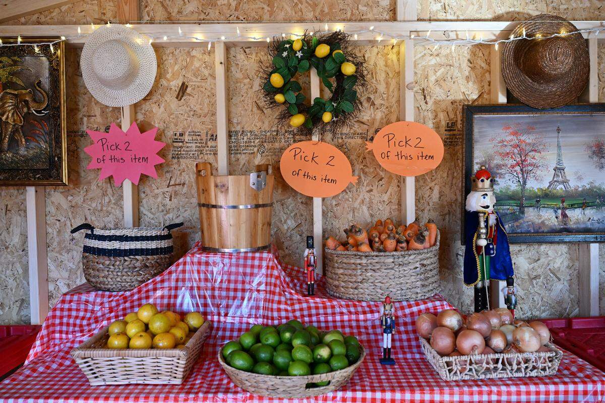 Onions, carrots and other local produce sit on display inside of the Sweet Valley Harvest Barn on Thursday, Dec. 11, 2025 at Sweet Valley Farm in Fort Valley, Georgia. Shoppers can get a bag of produce for $10, which includes a variety of fruits and vegetables. 