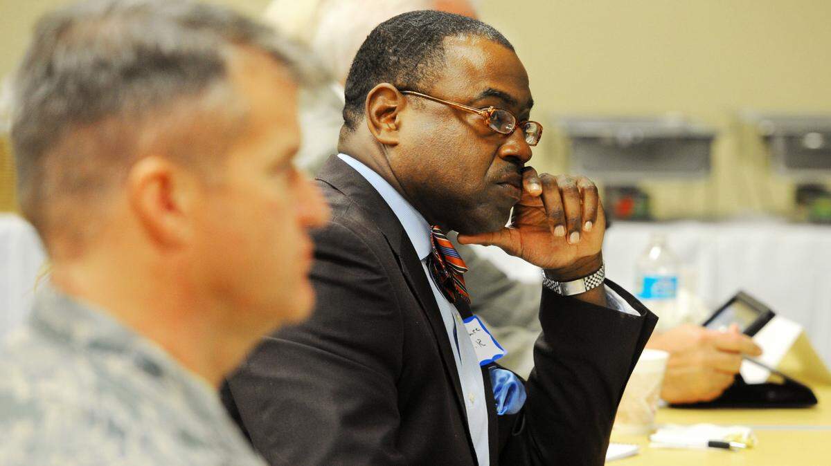 Gary Lee, director of the Warner Robins Economic Development Department, is shown at right in this 2014 file photo. Lee has been suspended without pay after his indictment on a felony charge of giving a false statement to a Houston County sheriff’s investigator during a criminal investigation. Lee is innocent of charges against him, one of his attorneys said Friday.