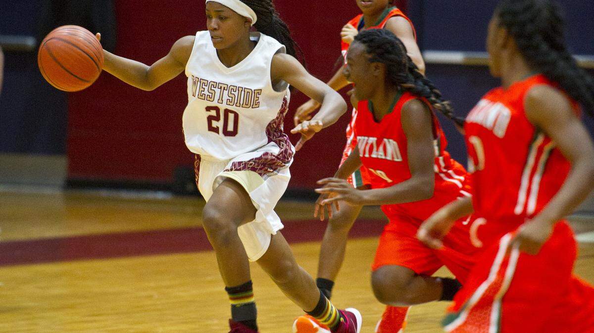 Westside's Niaira Dawson (20) brings the ball down the court against Rutland in the first half of Tuesday's girls basketball game.