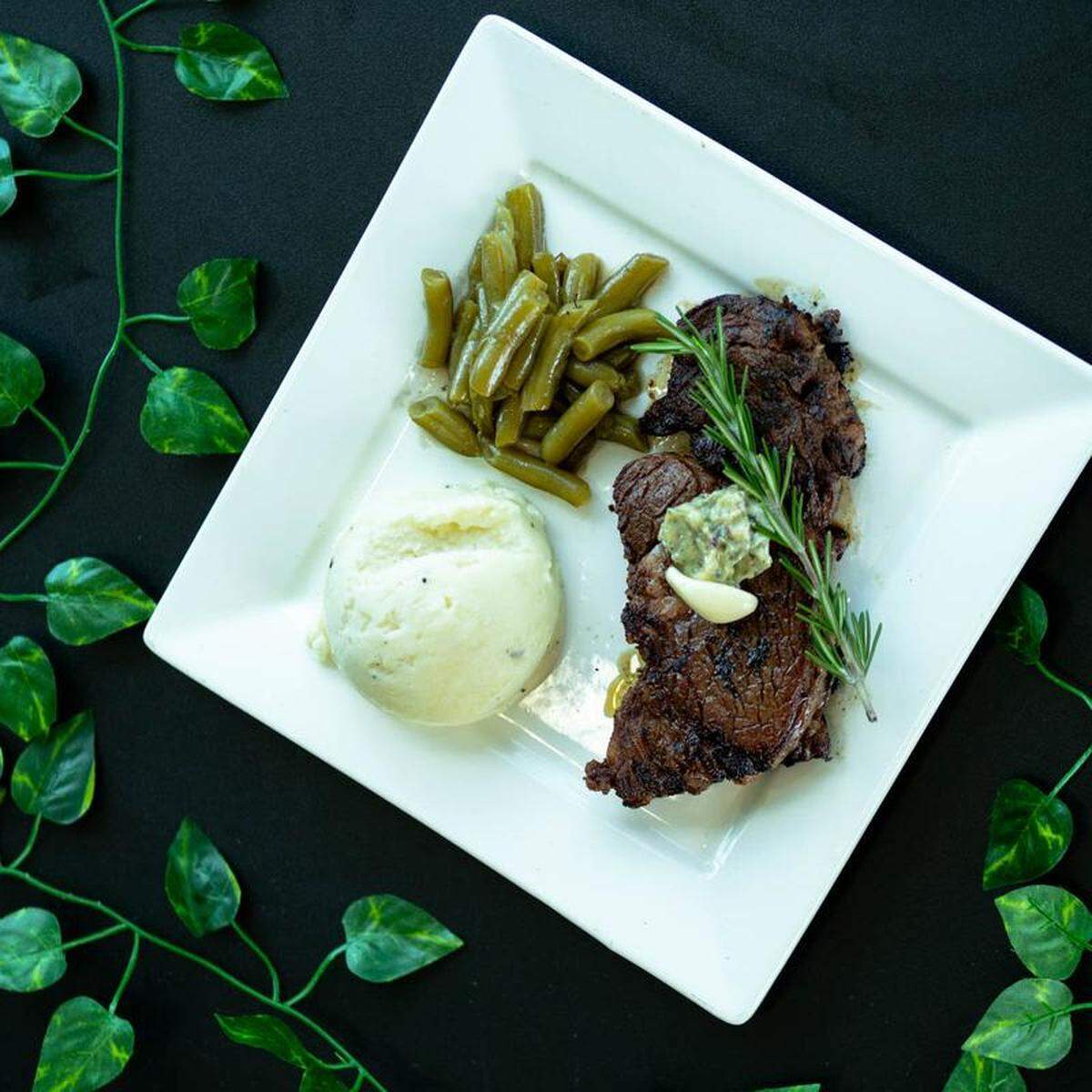 A 10 ounce pan-seared ribeye steak served with green beans and mashed potatoes at Prominent Bar and Restaurant in Byron.