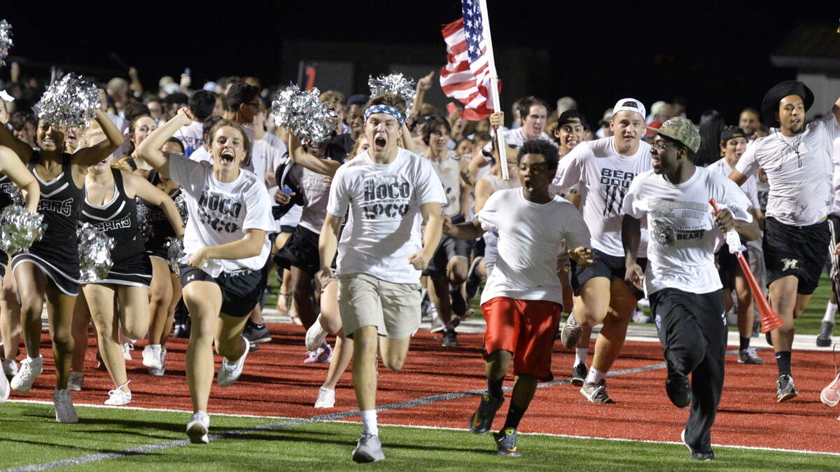 Houston County students and cheerleaders run onto the field after the Bears' win over Northside on Friday night.
