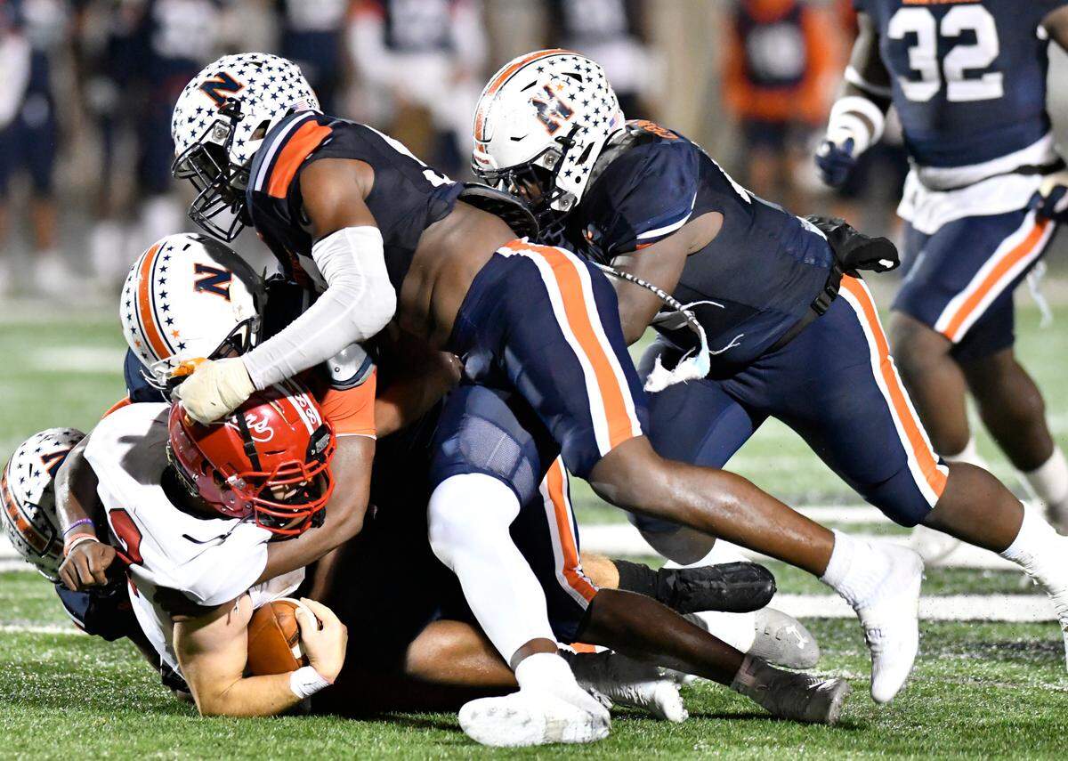 Glynn Academy quarterback Tyler Devlin (3) is sacked by Northside defenders during their first round playoff game.
