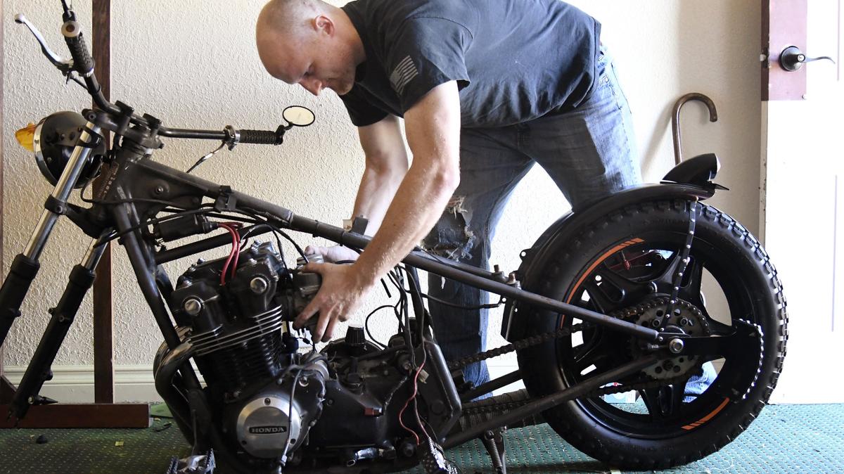 U.S. Army veteran Jason Cormier takes the carburetor off his custom 1981 Honda 750 motorcycle Nov. 3, at the Home Port Veterans Transition Home in Macon. Cormier’s house was foreclosed on after he and his wife divorced after his final deployment. Cormier is currently living at the Transition Home while majoring in interdisciplinary studies at Middle Georgia State University.