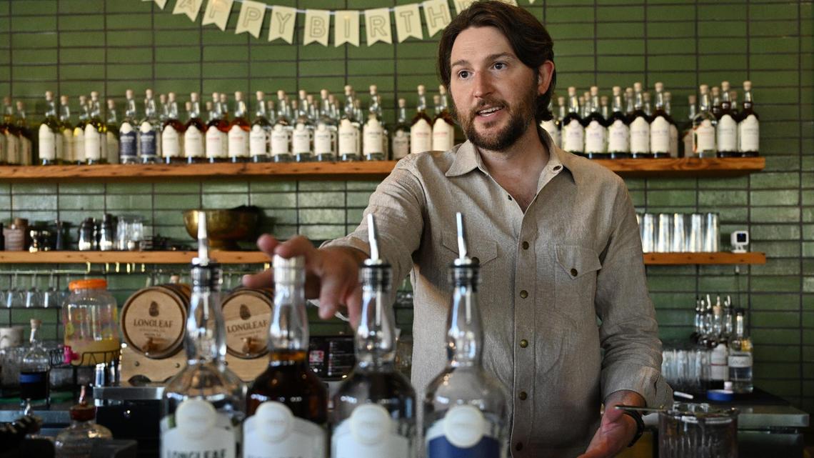 Longleaf Distillery Co. co-owner Will Robinson explains some of the spirits created in house during Longleaf’s second birthday celebration on Saturday, April 19, 2025, in Macon, Georgia. Longleaf Distillery Co. committed to planting one longleaf pine tree for every “Birthday Suit” signature cocktail sold on Saturday, on top of their commitment to plant a tree for every bottle of spirits sold.