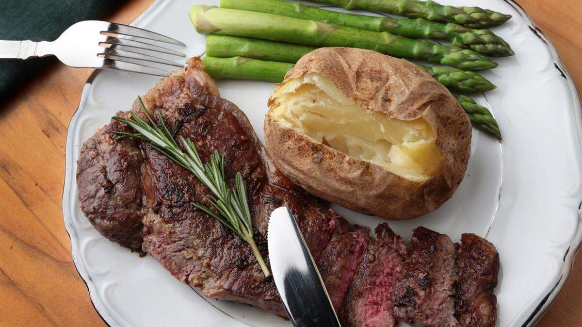 ROBERT COHEN/ST. LOUIS POST-DISPATCHDijon-Rosemary Steak is served with a potato and asparagus.