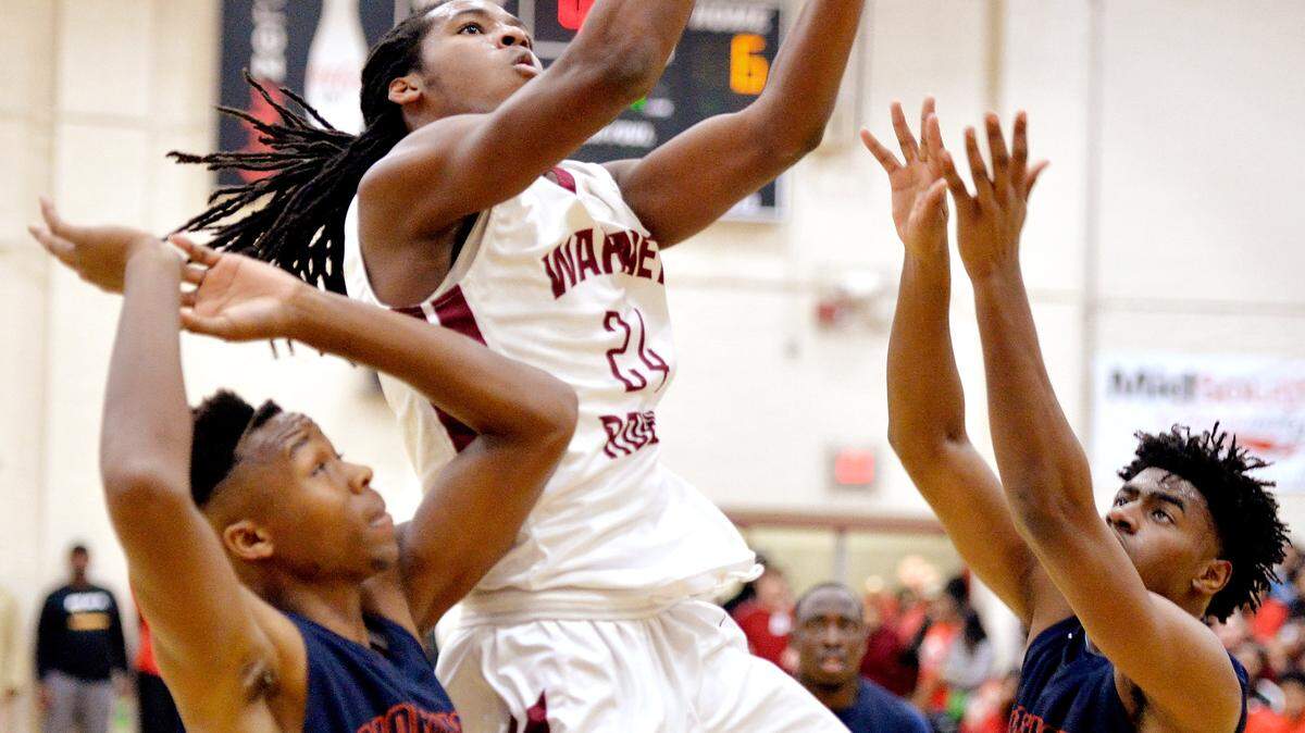 Warner Robins guard Marquez Callaway (24) puts up a shot during the Demons' game against Northside on Saturday
