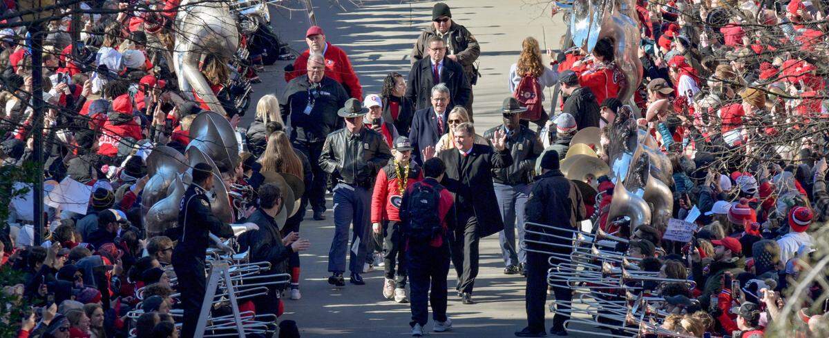 Georgia head coach Kirby Smart waves to the crowd outside Sanford Stadium during Saturday’s celebration in Athens.