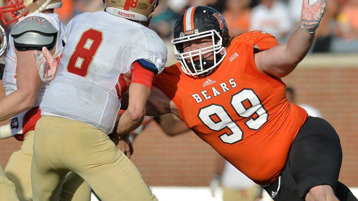 Mercer defensive end Austin Barrett (99) closes in on a sack of VMI quarterback Al Cobb (8) in the second half in their game in October.