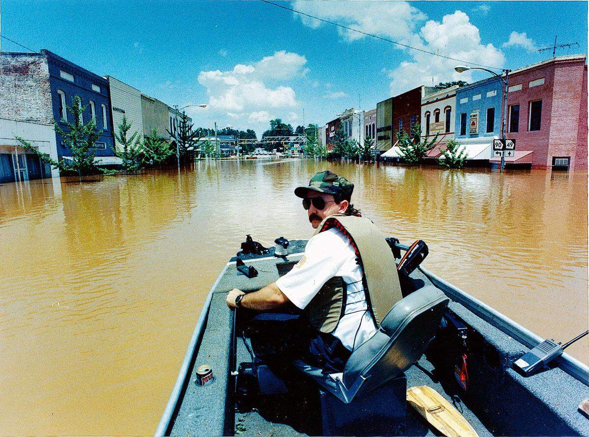 Ken Purdy of the Macon County Rescue Squad floats down Highway 90 in downtown Montezuma while touring the town.