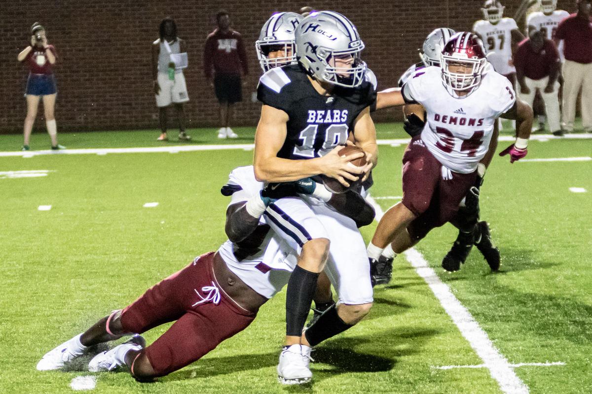 Houston County’s quarterback Max Rigby is tackled for a loss by Warner Robins’s Jaren McWilliams on Friday, Oct. 4, 2019.