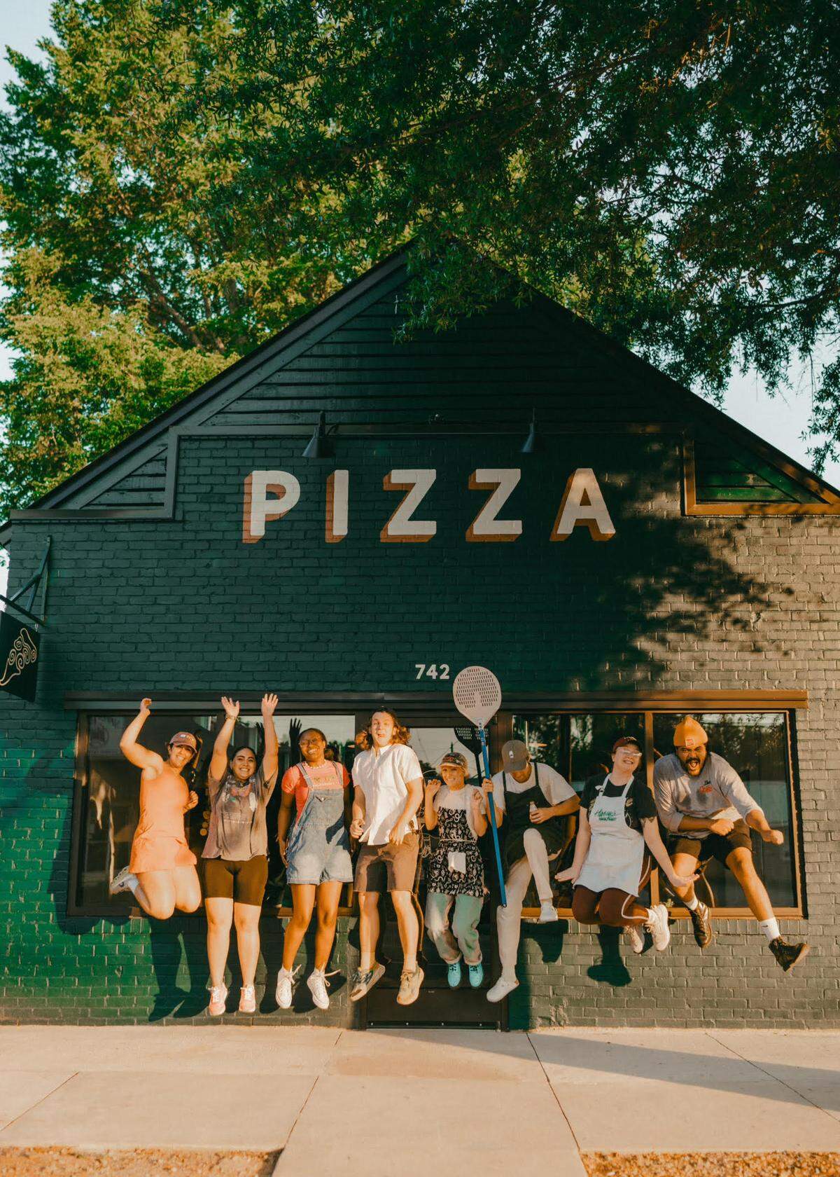 Ghost Runner Pizza opens in historic downtown Perry. The staff before an earlier friends and family night.