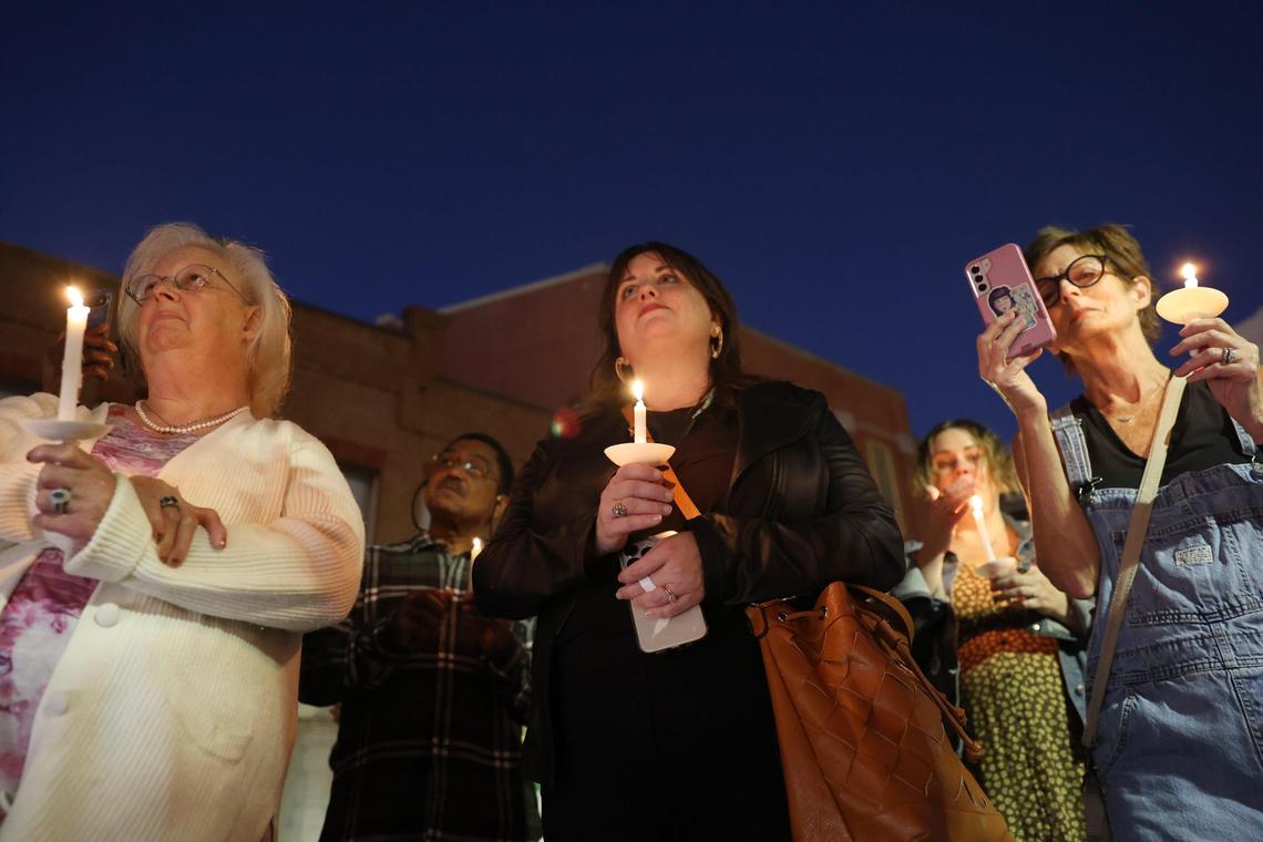 Attendees listen to Andrea Cooke from Macon Mental Health Matters during a candlelight vigil hosted in the Cotton Avenue Plaza on Tuesday, Nov. 12, 2024, in downtown Macon, Georgia. Rather than honoring the life of someone who has passed, organizers said that the vigil was an opportunity for members of the LGBTQ+ community and allies to gather following the results of Election Day a week prior.