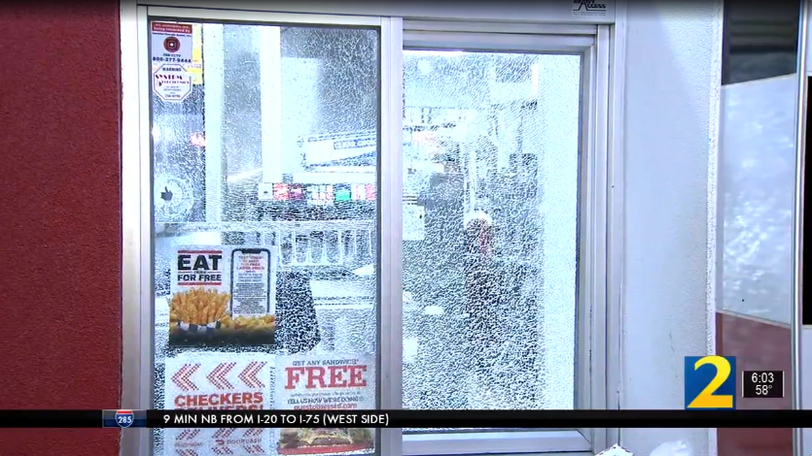 Video by WSB-TV shows shattered glass and a bullet hole following a shooting late Tuesday night at a Checker’s in Dekalb County, Georgia.