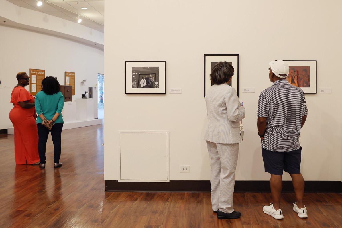 Attendees walk through the exhibit at the opening reception for “Thrillers: Black Music in Atlanta 1960s-1990s” on Sunday, July 28, 2024, at the Tubman Museum in Macon, Georgia. The Tubman’s newest exhibit features decades of Black music photography from Atlanta based photographer Bud Smith.