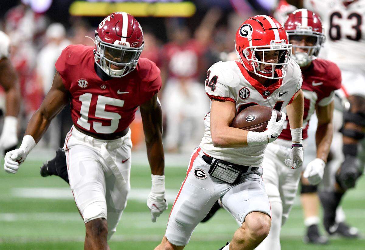 Georgia receiver Ladd McConkey (84) runs into the end zone for a touchdown Saturday during the Bulldogs’ SEC Championship game against Alabama.