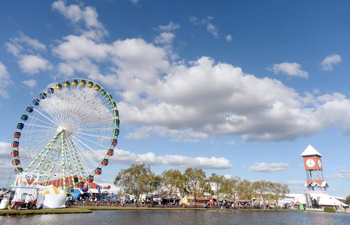 JASON VORHEES/THE TELEGRAPH Macon, GA, 10/05/2017: The world’s largest traveling ferris wheel standing at over 150 feet dwarfs the clock tower at the Georgia National Fair.