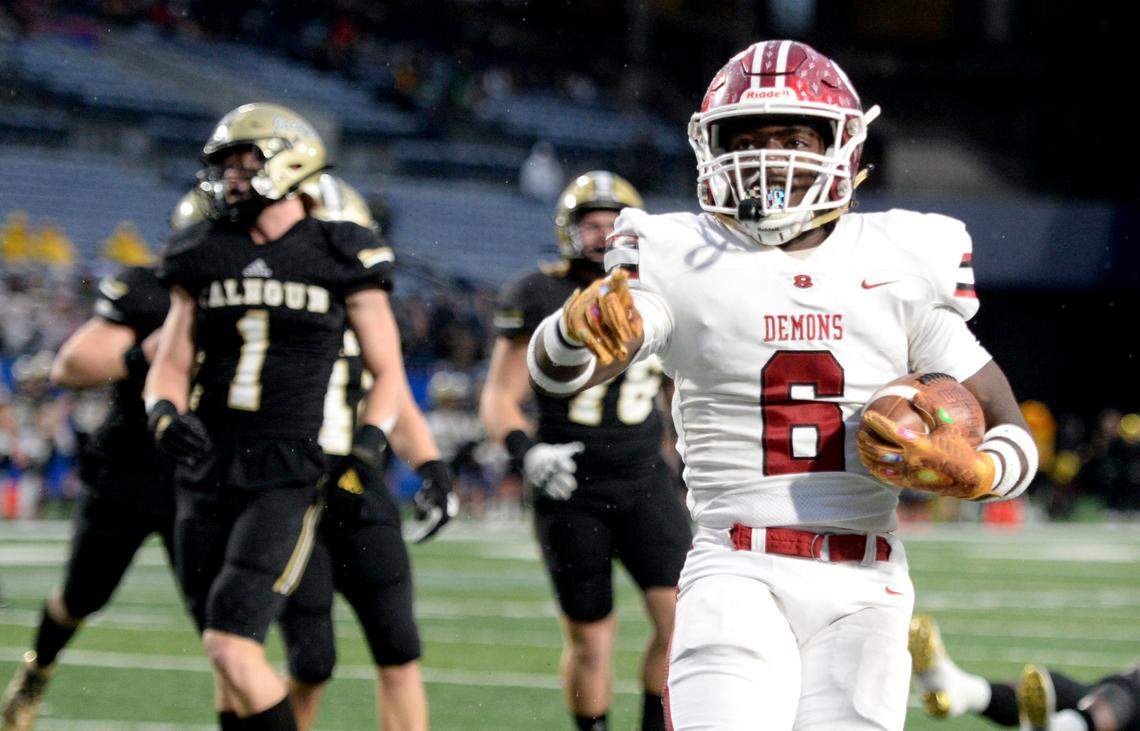 Warner Robins running back Jafredrick Perry (6) runs into the end zone for a touchdown in the first quarter of the Demons’ GHSA 5A State Championship win over Calhoun Saturday in Atlanta.