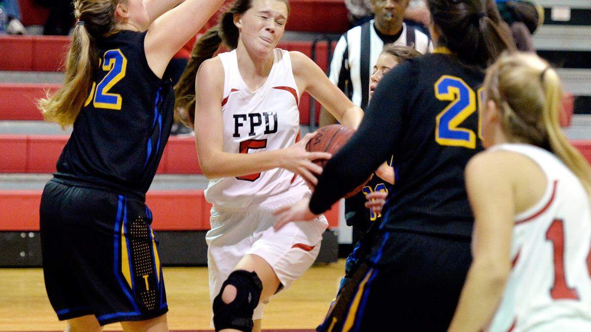 FPD's Kate Patterson (5) braces for contact while driving to the basket during their game against Tattnall Tuesday night.