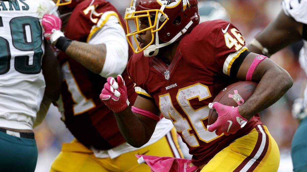 In this Oct. 4, 2015, file photo, Washington Redskins running back Alfred Morris (46) runs the ball during the second half of an NFL football game against the Philadelphia Eagles in Landover, Md. The Redskins lead the NFL in rushing with their running back tandem of Alfred Morris and Matt Jones.