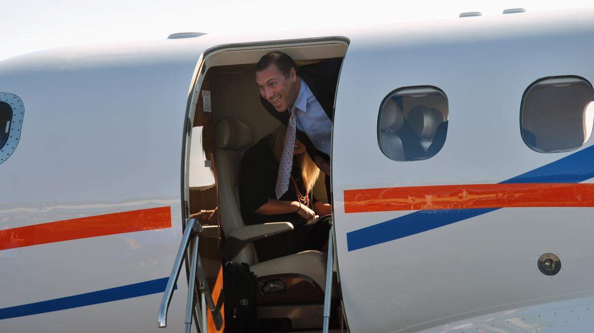 Florida head coach Dan Mullen gets off a team airplane following his hiring.