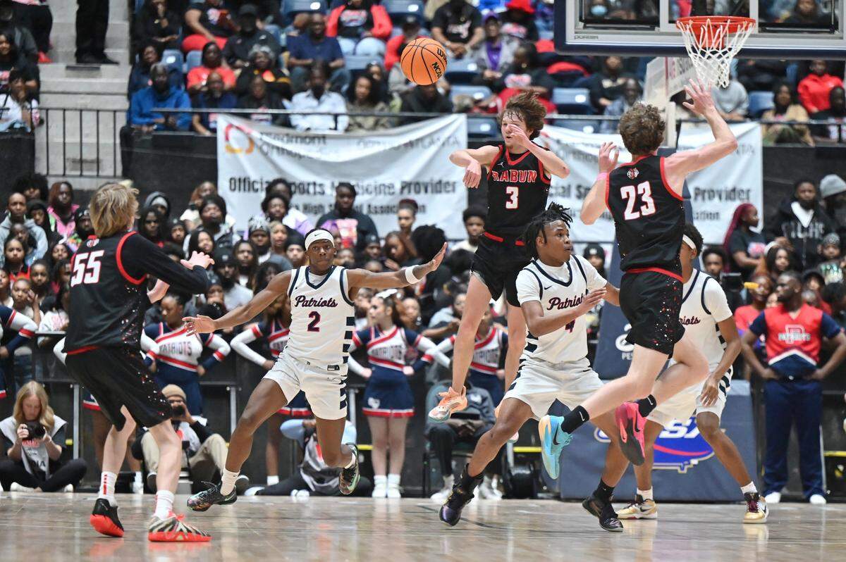 Rabun County senior point guard Huey Blalock (3) passes the ball while Southwest defends during the GHSA Class A Division 1 state championship on Friday, March 13, 2026, at Macon Coliseum in Macon, Georgia. Southwest High School boys basketball lost to Rabun County 52-43. 