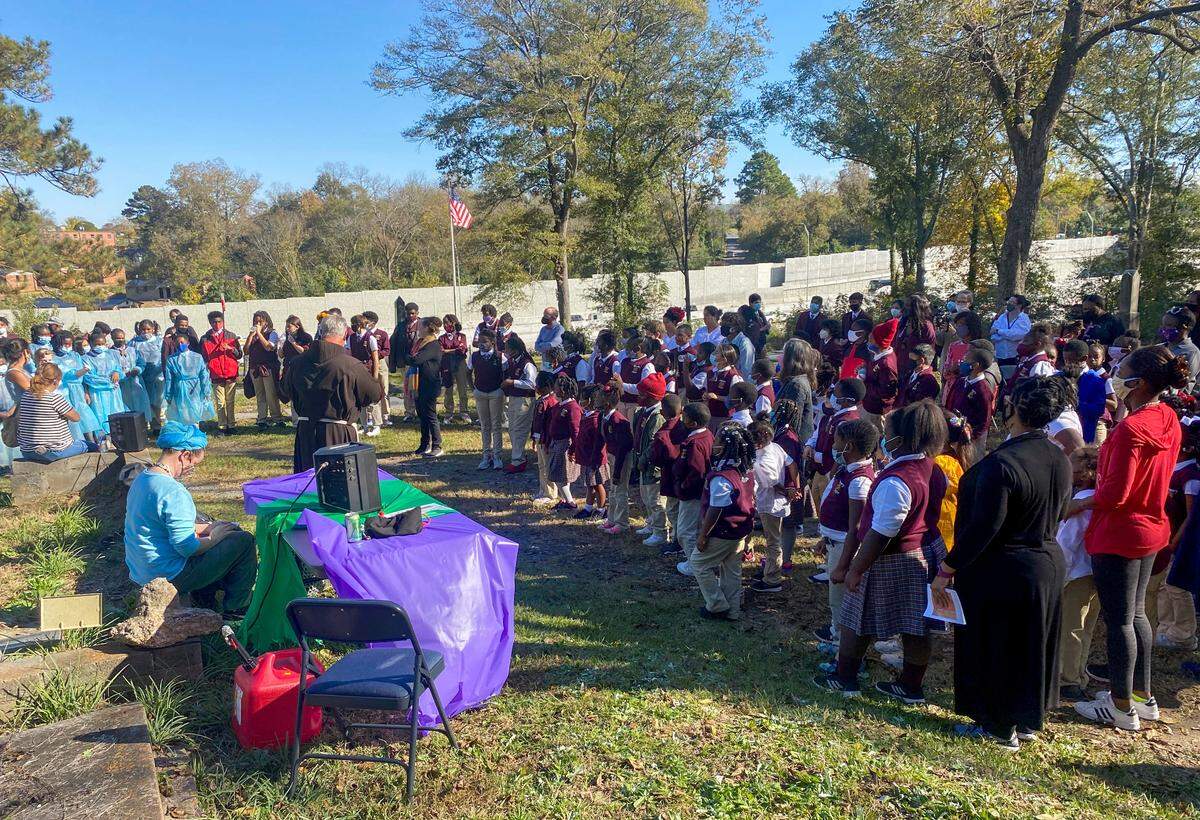 Students an faculty from St. Peter Claver at Linwood Cemetery during a Day of the Dead program Oct. 31. Photo Courtesy of Macon Cemetery Preservation Corporation