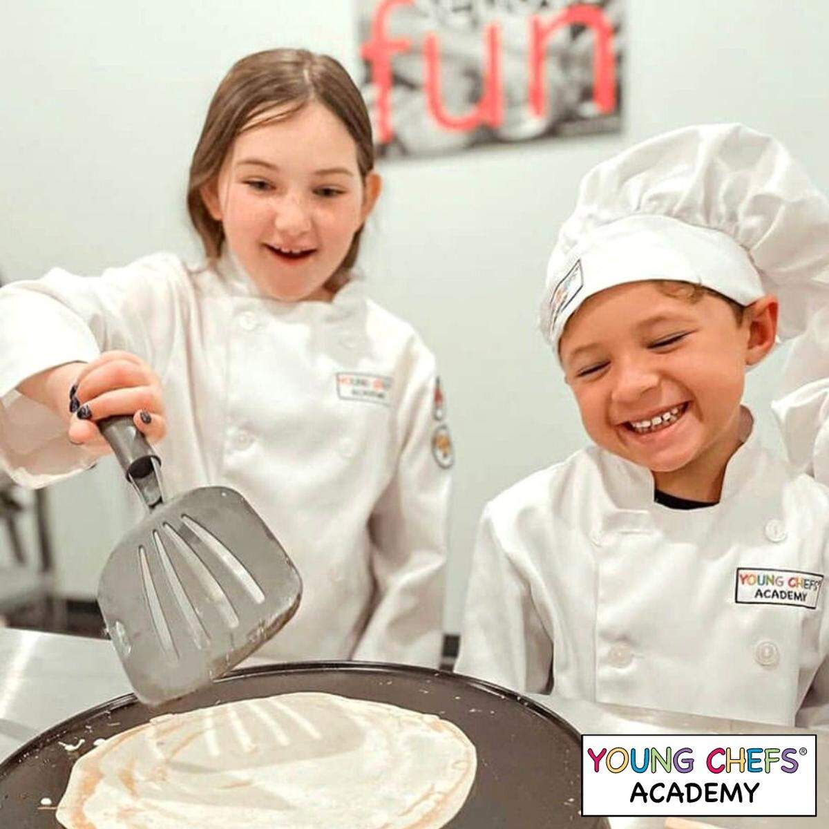Kids making pancakes at a Young Chefs Academy.