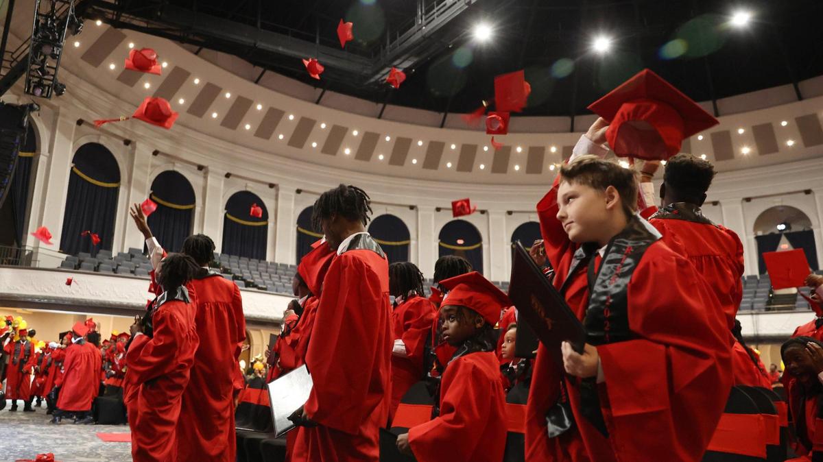 R.I.S.E graduates throw their caps in the air at the R.I.S.E graduation on Thursday, Dec. 19, 2024, at the Macon City Auditorium in Macon, Georgia. Macon Judicial Circuit District Attorney Anita Howard began the Restoring Inspiration by Success in Education initiative in 2022 to support Macon-Bibb County youth impacted by adverse childhood experiences. The number of graduates, or students that completed the program, nearly doubled since 2023.