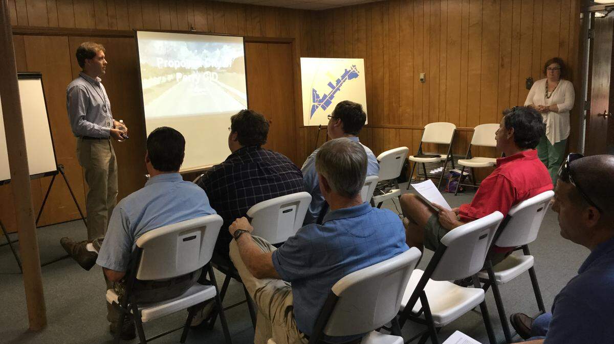 Perry’s Director of Economic Development Robert Smith shows a presentation explaining how a Community Improvement District works to about 20 commercial property owners along General Courtney Hodges Boulevard.
