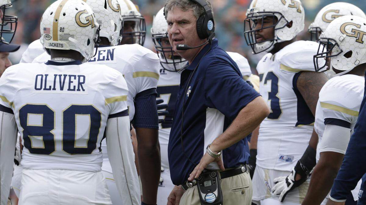 Georgia Tech head coach Paul Johnson talks with his players during the first half of an NCAA college football game against Miami, Saturday, Nov. 21, 2015 in Miami Gardens, Fla.