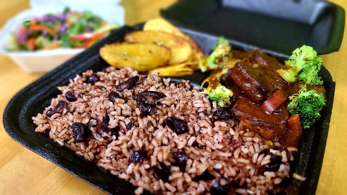 Brown Stew Vege Chicken with rice and beans served with a vegetable salad and plantains at Roots Plant Based Cafe in Byron.