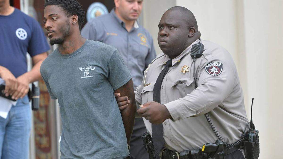 Bibb County sheriff's deputies take Shavez Flewellen to jail after questioning him at the Detective Bureau in connection with the fatal shooting of Jarvis Webb, 23.