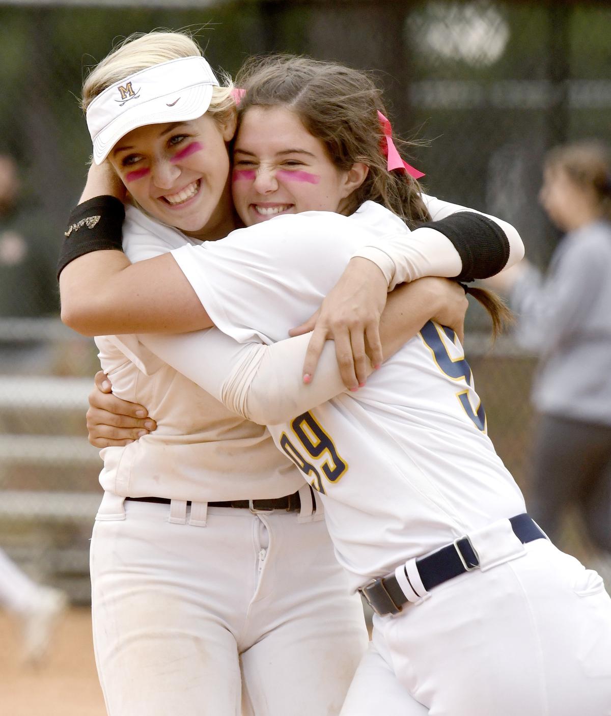 Mount de Sales Academy shortstop Henderson Hurdle (15) hugs pitcher Jordyn Partain (99) after their 3-0 win over Stratford Thursday during the GHSA state tournament in Columbus.