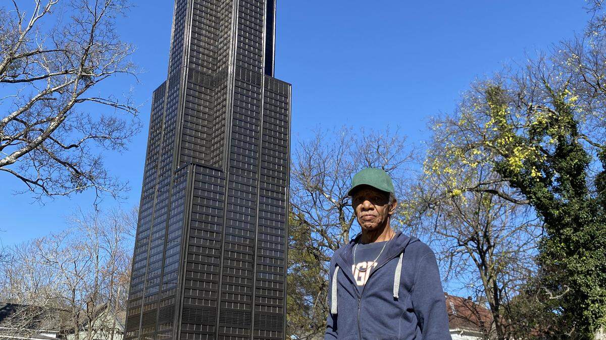 Macon’s Jesse Evans with replica Willis Tower in front of his home on Elm Street. Evans, who once headed a cryogenics program for NASA, spent more than two years constructing the 16-feet, 4-inch, 1,600-pound replica of the building once known as the Sears Tower.