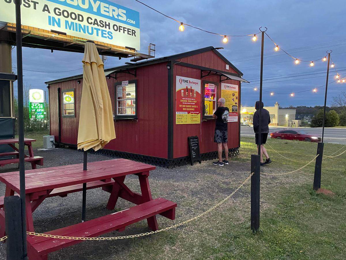 Darrell Mount, at the window, and Craig Jones, swing by shortly before closing to pick up some dinner to go at Q Time Barbeque Food Company in Warner Robins.