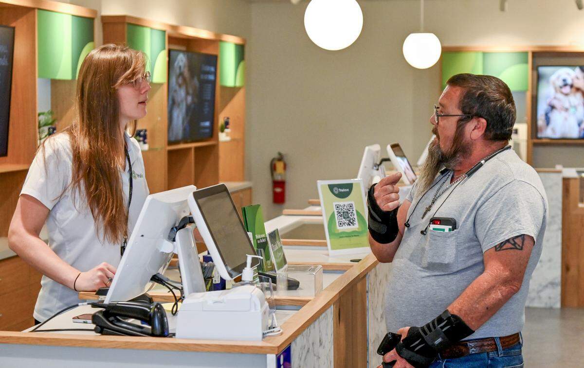 Trulieve Dispensary associate Michelle Dubiel helps Tracey Crawford with a purchase on Wednesday at the Trulieve Macon Dispensary on Riverside Drive.