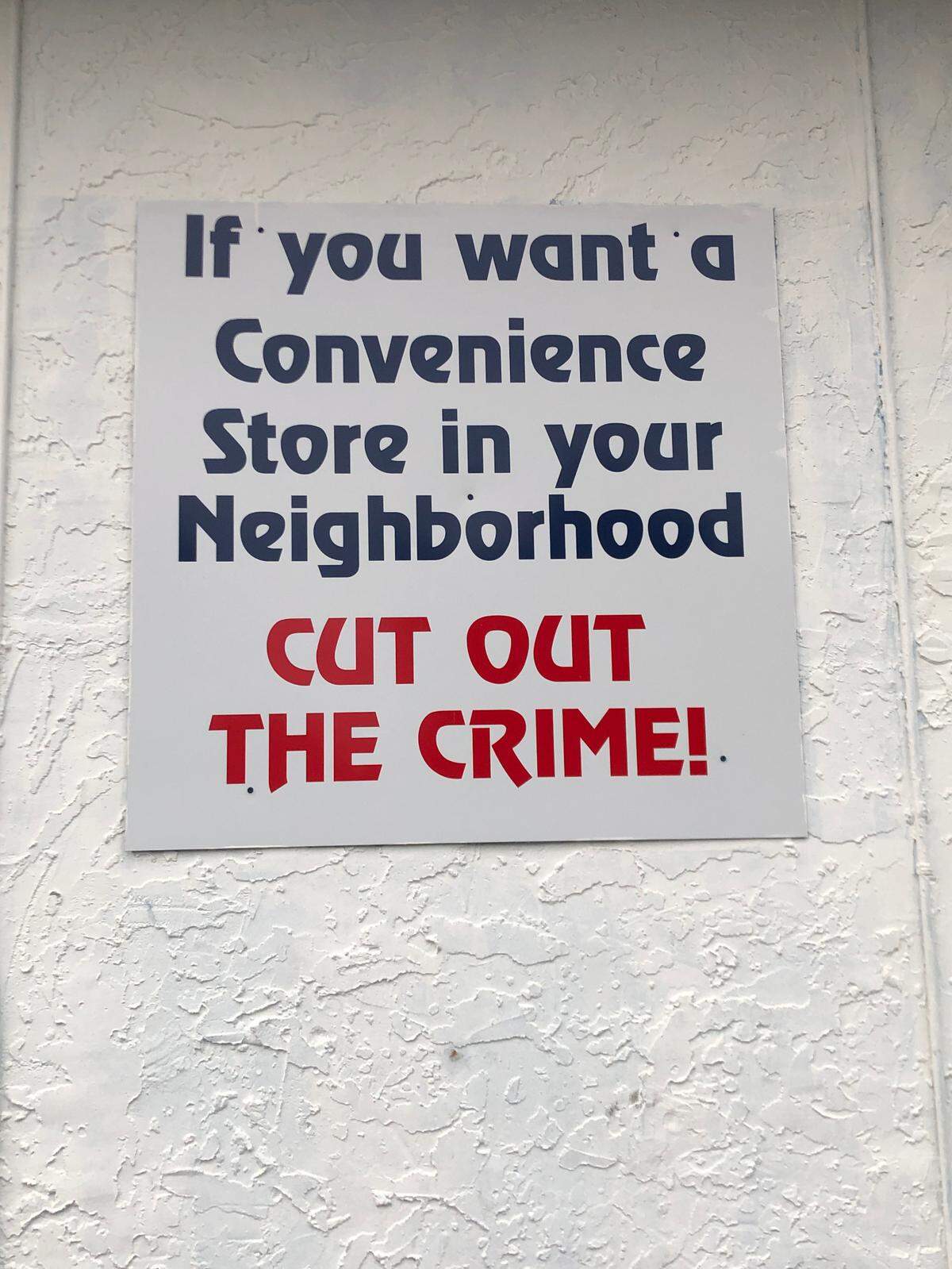 An anti-crime sign adorning the side of M&M Grocery, a convenience store accused of being complicit with the high-crime area of Montepelier Avenue it sits on.