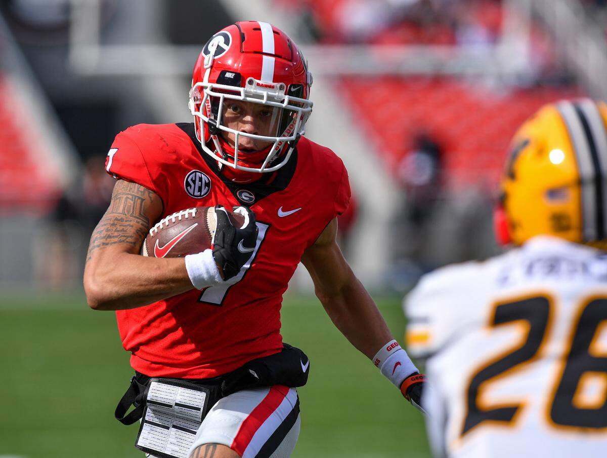 Georgia Bulldog Jermaine Burton swings around the end nad heads for the endzone against Missouri Saturday in Athens.