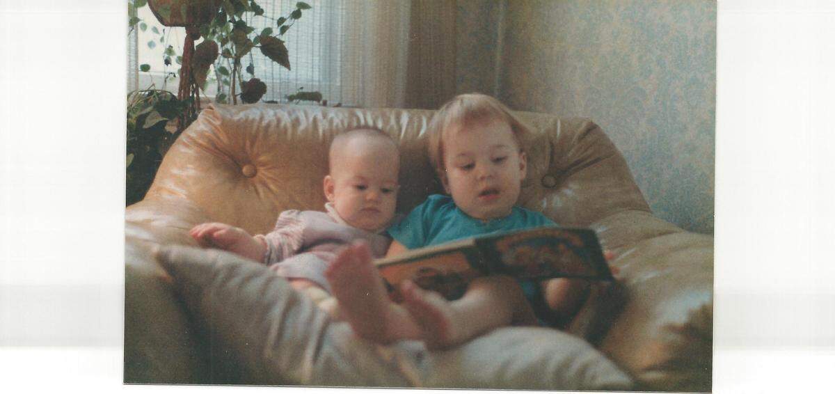 Larry Fennelly’s oldest son, at age 2, reads to his younger sister.