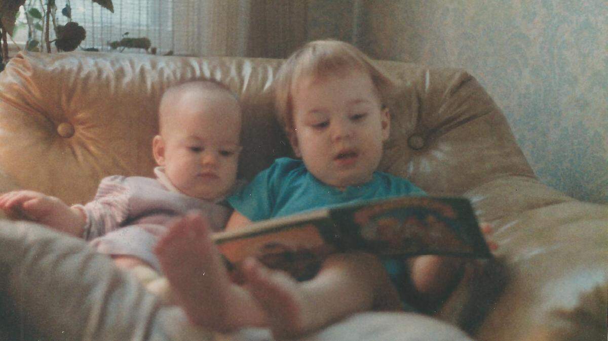 Larry Fennelly’s oldest son, at age 2, reads to his younger sister.