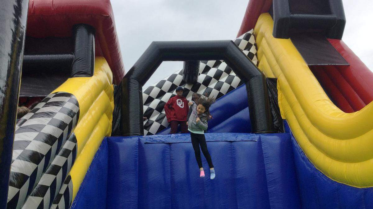 Olivia Sanchez, 8, of Phenix City, Alabama, leaps from the Tractor Jump at the Peach Blossom Festival on Saturday at Lane Southern Orchards, 50 Lane Rd, Fort Valley. She was a little hesitant and scared at first, said her dad, Kenneth Sanchez. But now that she’s been doing it over and over again, she knows her stuff, he said.