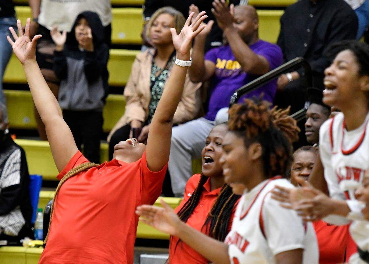 Baldwin head coach Kizzi Walker celebrates the Braves’ 58-45 GHSA 4A semifinal win over Holy Innocents’ Saturday at Fort Valley State. Baldwin will play Griffin Wednesday, March 8 at 5 p.m. at the Macon Coliseum.