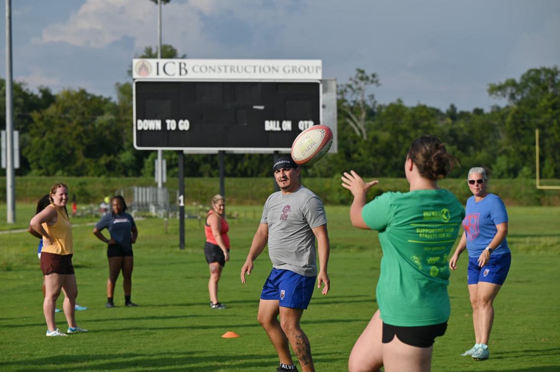 Margaret Peth (right) passes the ball to David Dixon during Macon Love Rugby on Thursday, Aug. 8, 2024, at Central City Park in Macon, Georgia. Macon’s amateur rugby team is expanding their team by competing with an all-female team at a summer competition this weekend.