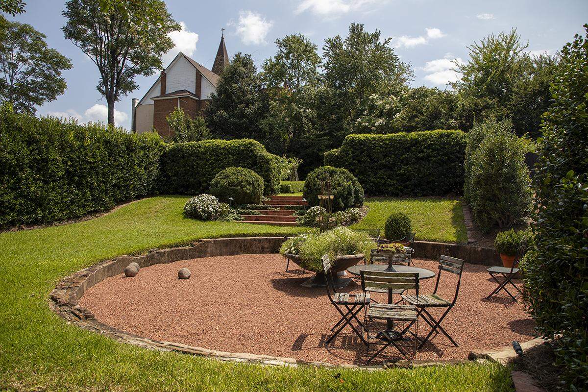 In their backyard, Carey Pickard and Chris Howard found a deep 30’x30’ cistern that had at one time held the city of Macon’s water supply. They excavated a few feet of it and it is now a hardscape for their garden. (Photo by Evey Wilson Wetherbee)