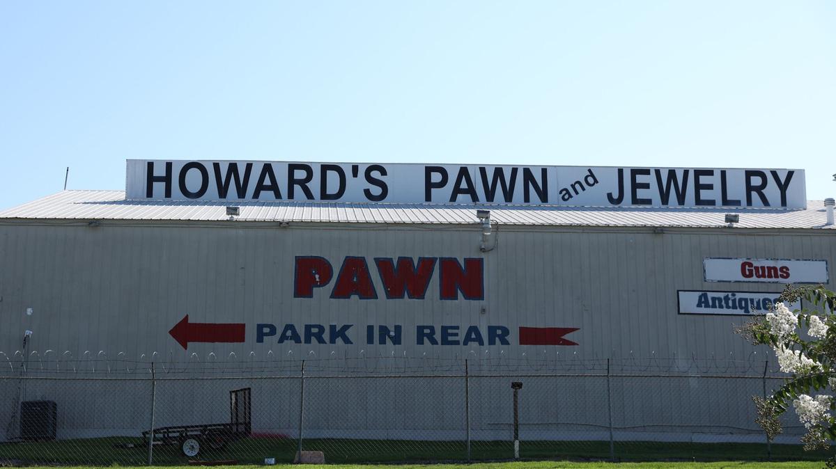 Howard’s Pawn & Jewelry sits off of Mercer University Drive on Monday, Aug. 12, 2024, in Macon, Georgia. Two burglars stole 62 guns from the shop last year and one of them is expected to plead guilty this week in federal court.